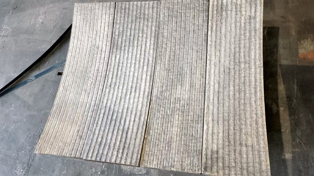 Curved wear liners laid side by side