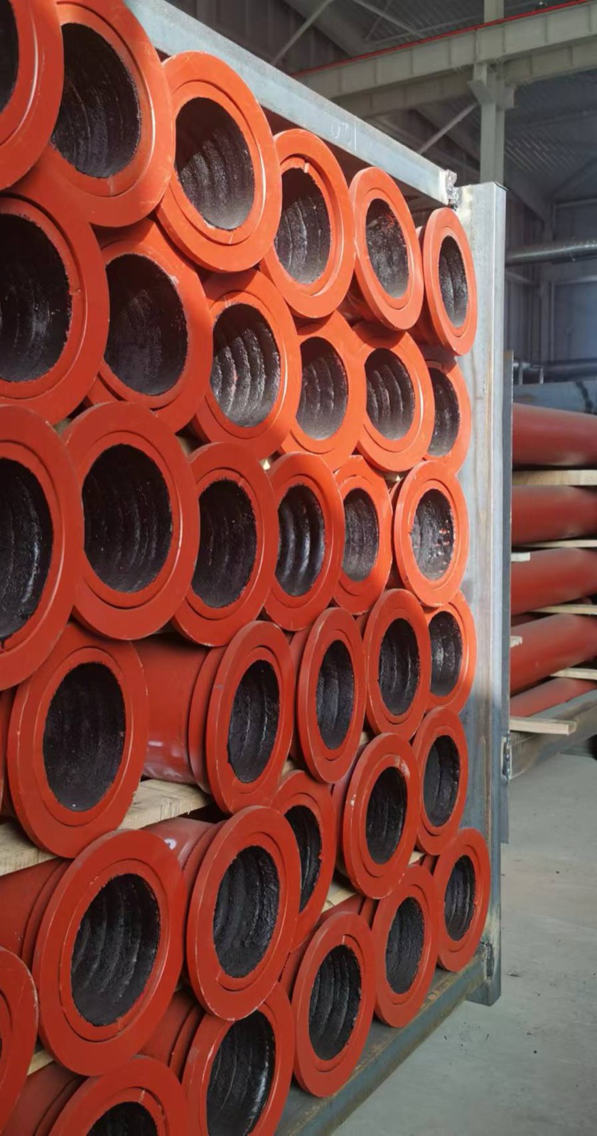 Rack of red flanged wear pipes