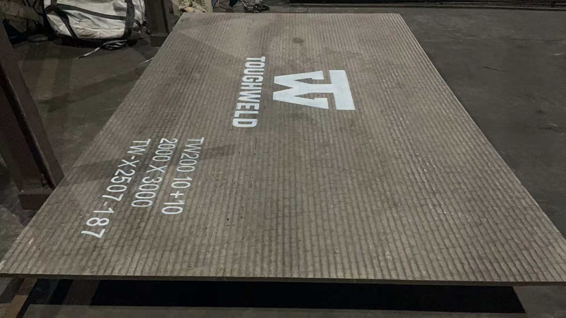 TW200 plate with TOUGHWELD stencil on the workshop floor